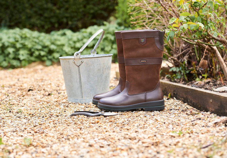 A pair of Dubarry Kildare calf height leather Country Boot, walnut brown colour sitting outside