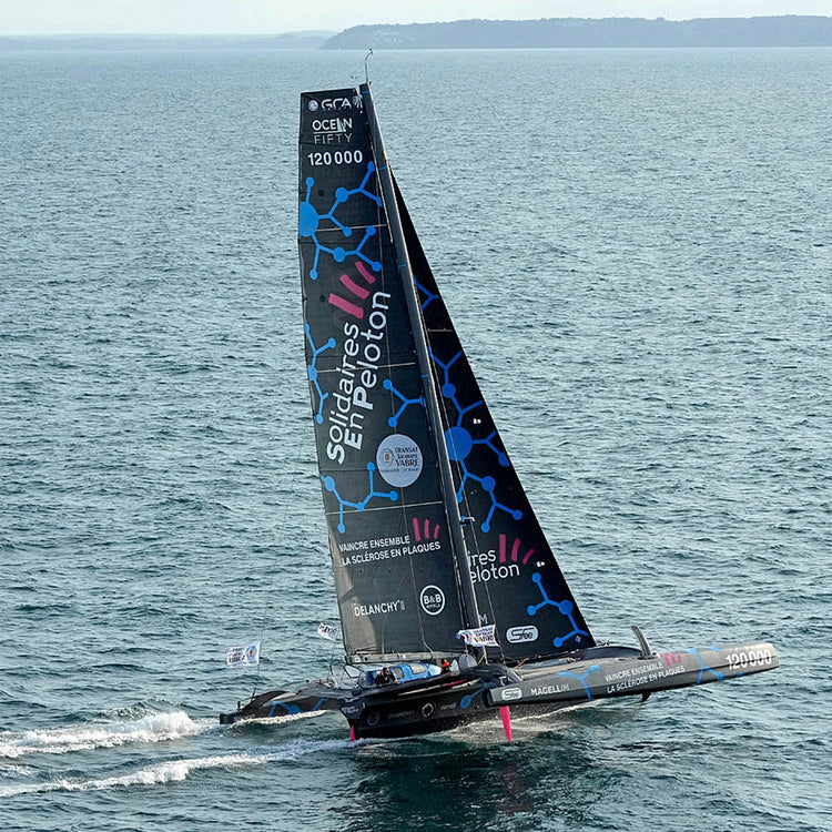 Square image of Thibaut Vauchel-Camus' vessel sails on a sunny day with blue skies and a blue ocean.//© Thibaut Vauchel Camus | Pierrick Contin